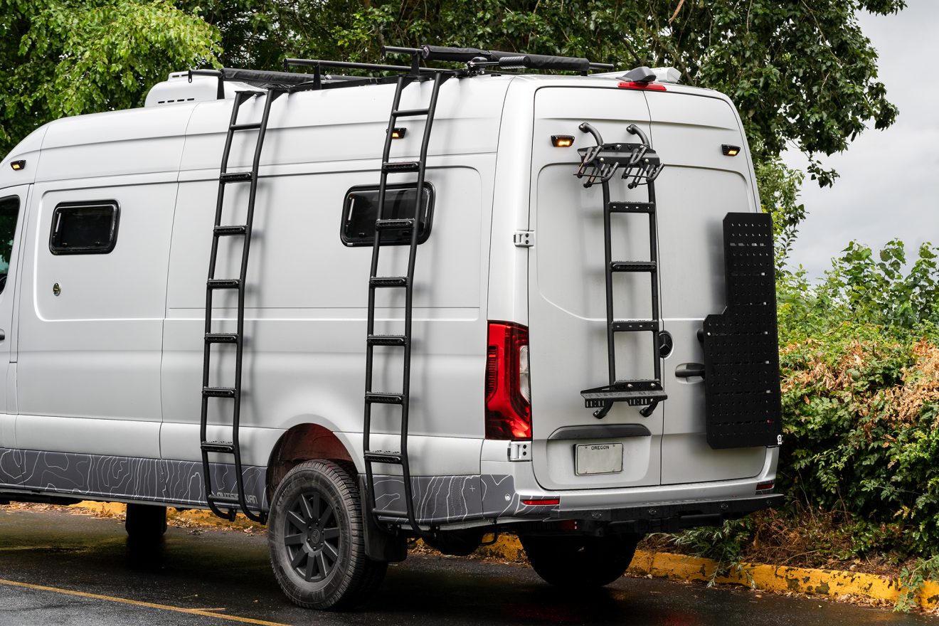 View of side and rear of the Sprinter van, roof cross bars, side Utility ladders, rear Utility ladder, Owl Sherpa