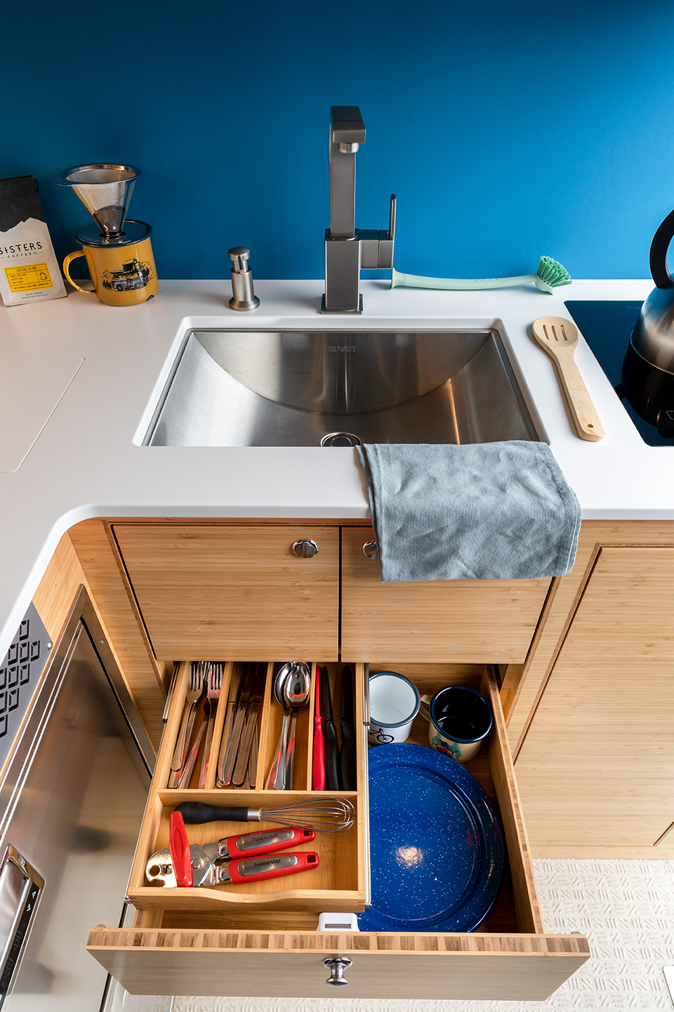Stainless steel sink, Corian countertop, storage drawers