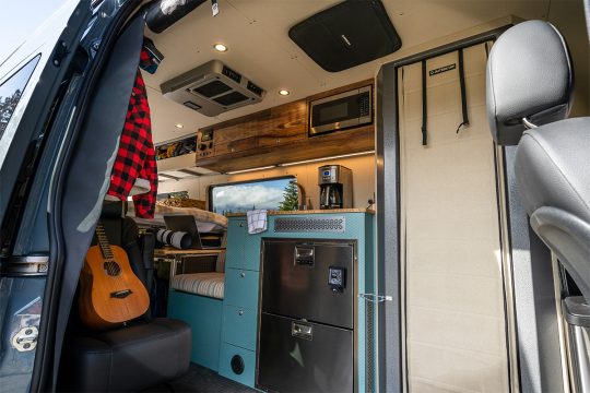 Interior van with enclosed aluminum shower, kitchen, and dot-approved passenger seat