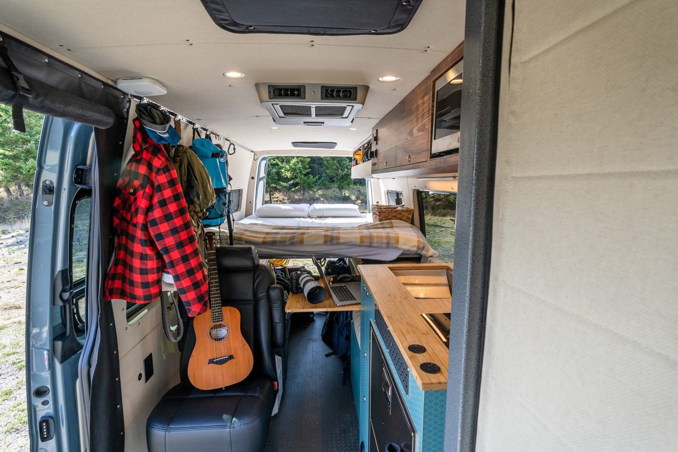 Interior van with enclosed aluminum shower, kitchen, and dot-approved passenger seat
