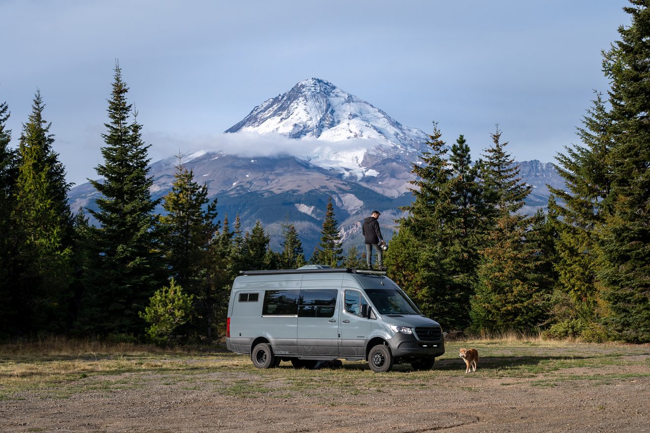 Blue van in open field near Mount Hood