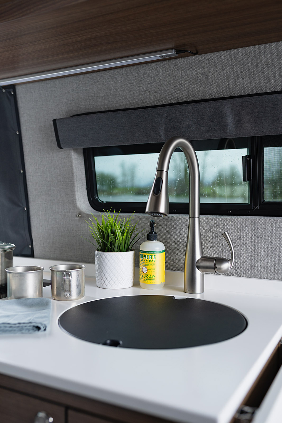 Galley kitchen counter with a faucet and covered sink