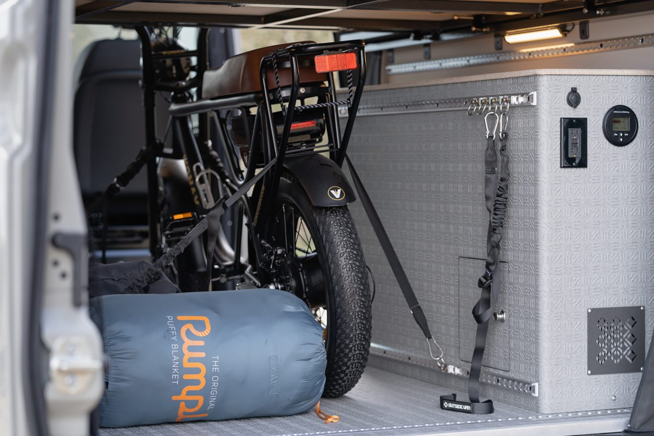 Rear interior of the garage storage area with an e-bike strapped down