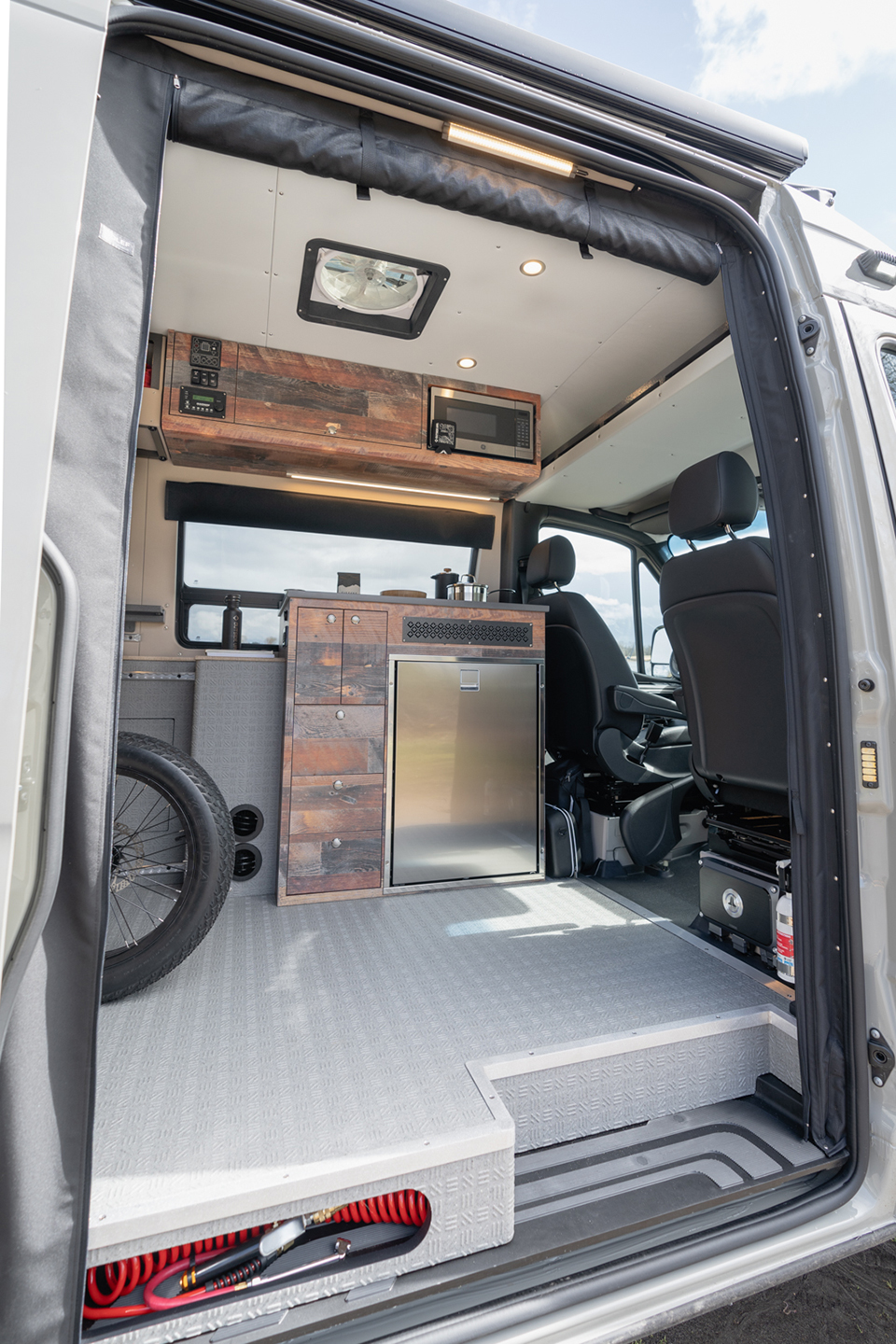 Interior of a van with an e-bike strapped down in the middle