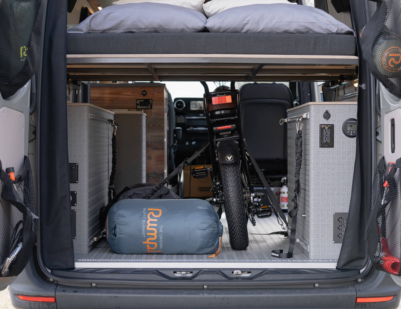 Rear interior of the garage storage area with an e-bike strapped down