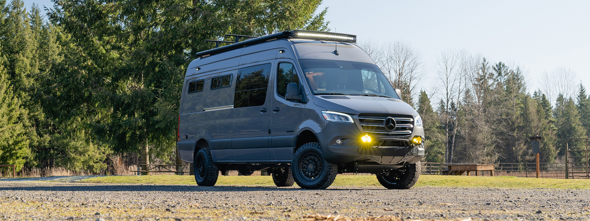 Exterior Mercedes-Benz Sprinter Van 170 with the lights on in a field
