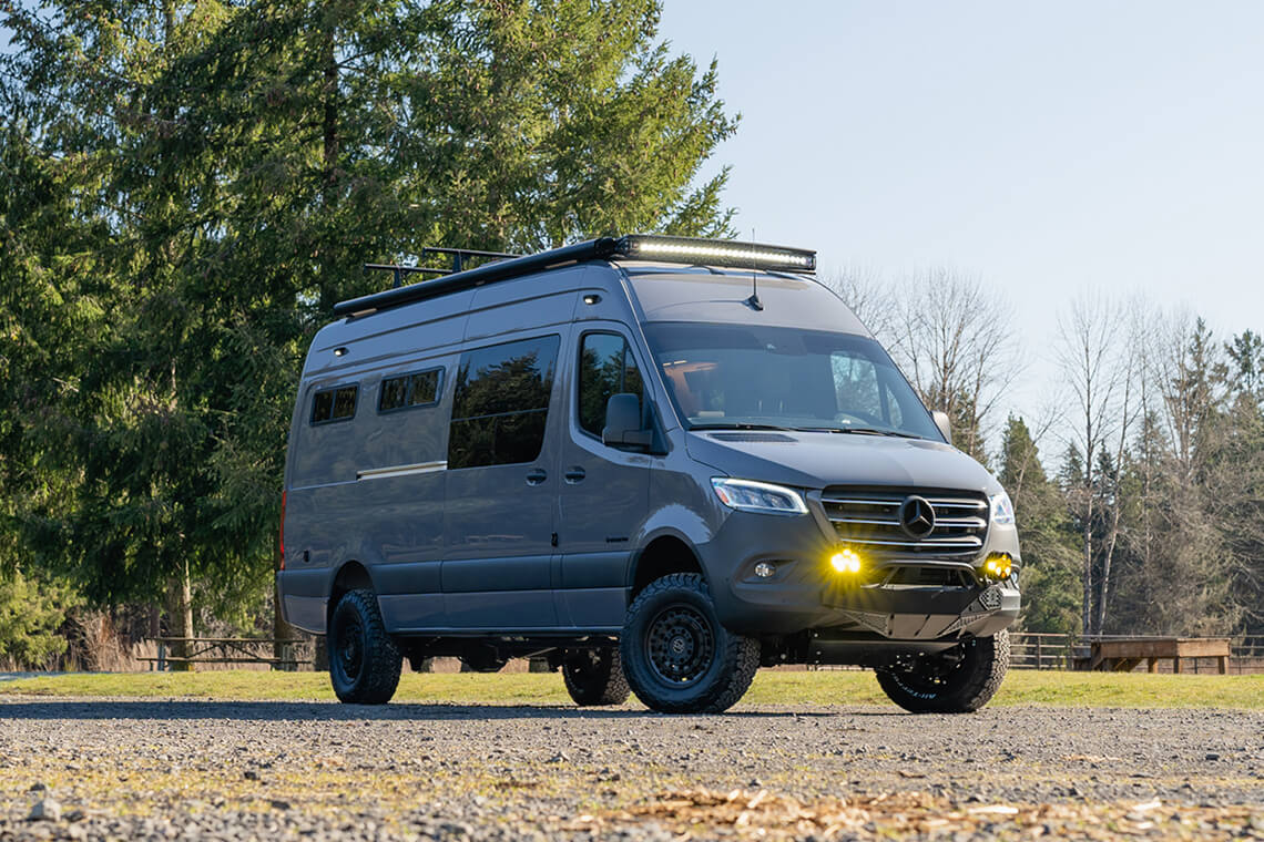 Exterior Mercedes-Benz Sprinter Van 170 with the lights on in a field