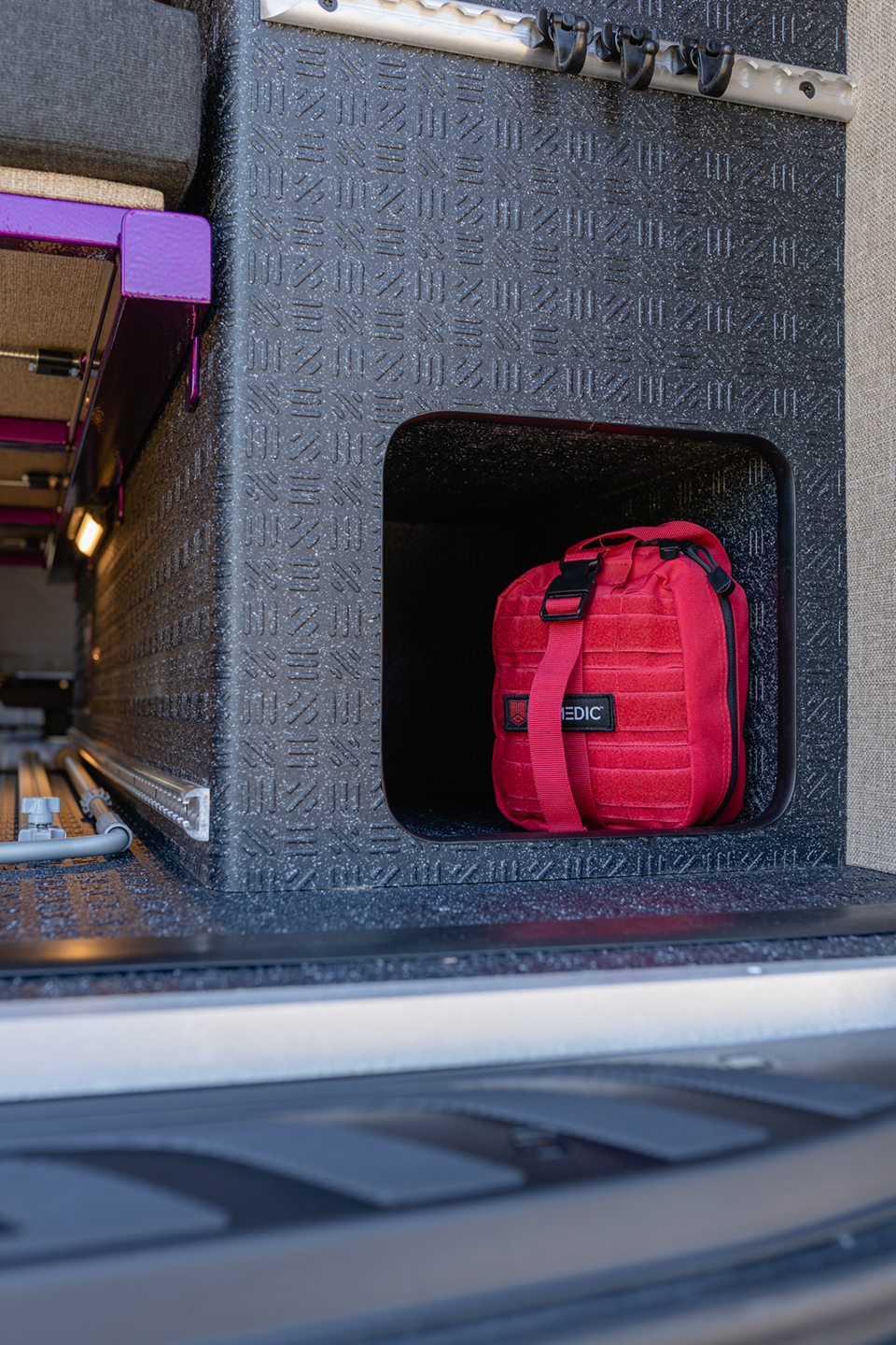 Interior garage cabinet wrapped in lonseal with a medical kit in the open compartment