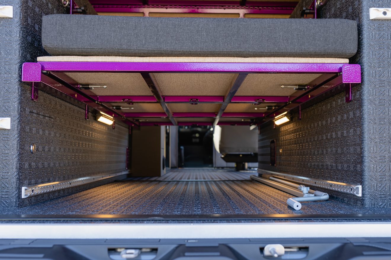 Garage interior looking toward the front of the van with purple powdercoating metal panels