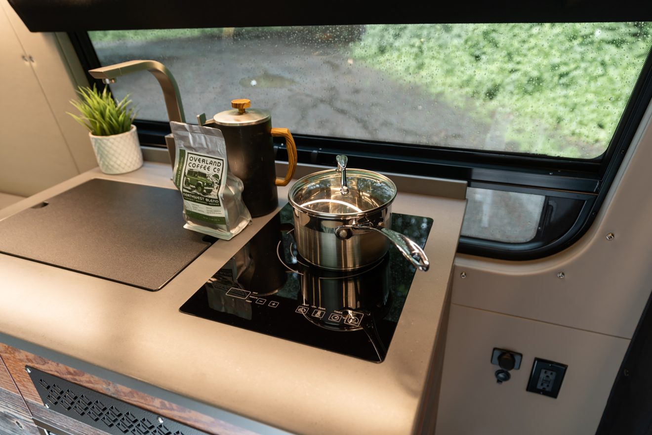 custom van conversion Trail Mix 2021 mercedes benz sprinter 170 4wd seat two sleep three induction stove cooktop