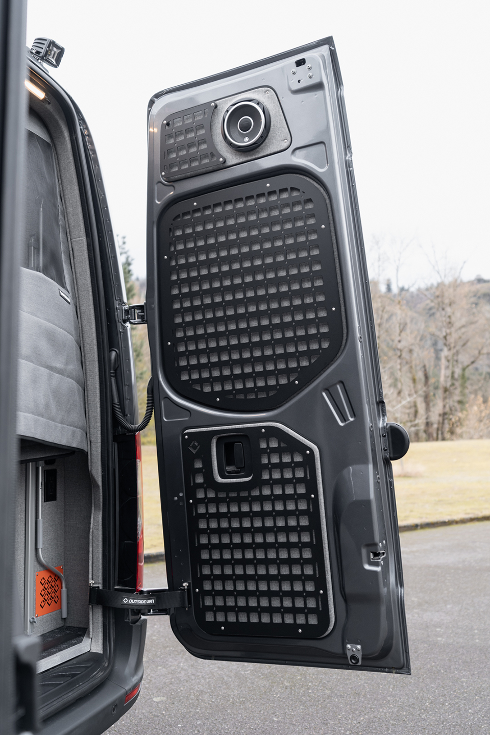Rear passenger-side doors featuring molle panels and speaker
