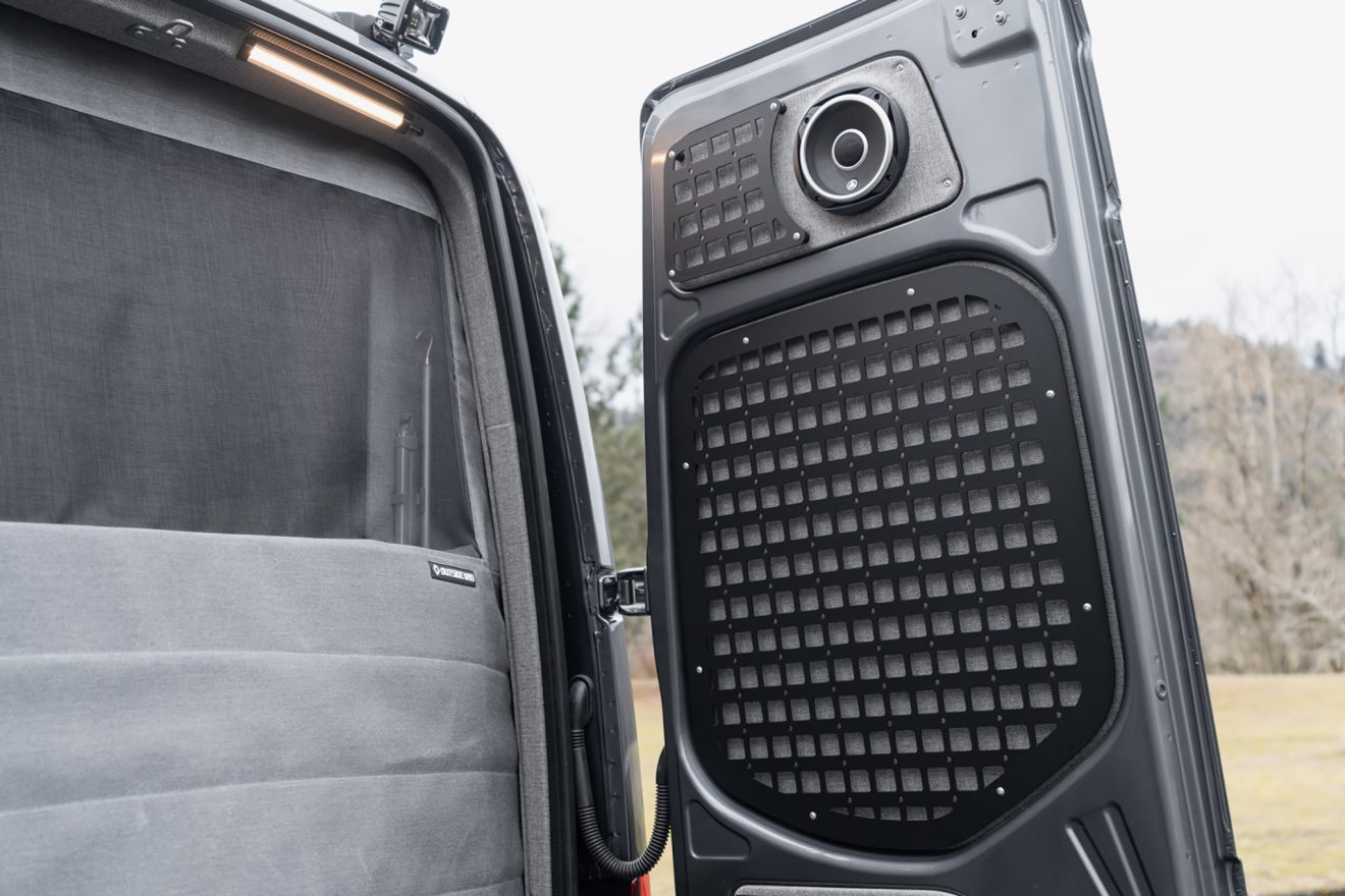 Rear passenger-side doors featuring molle panels and speaker