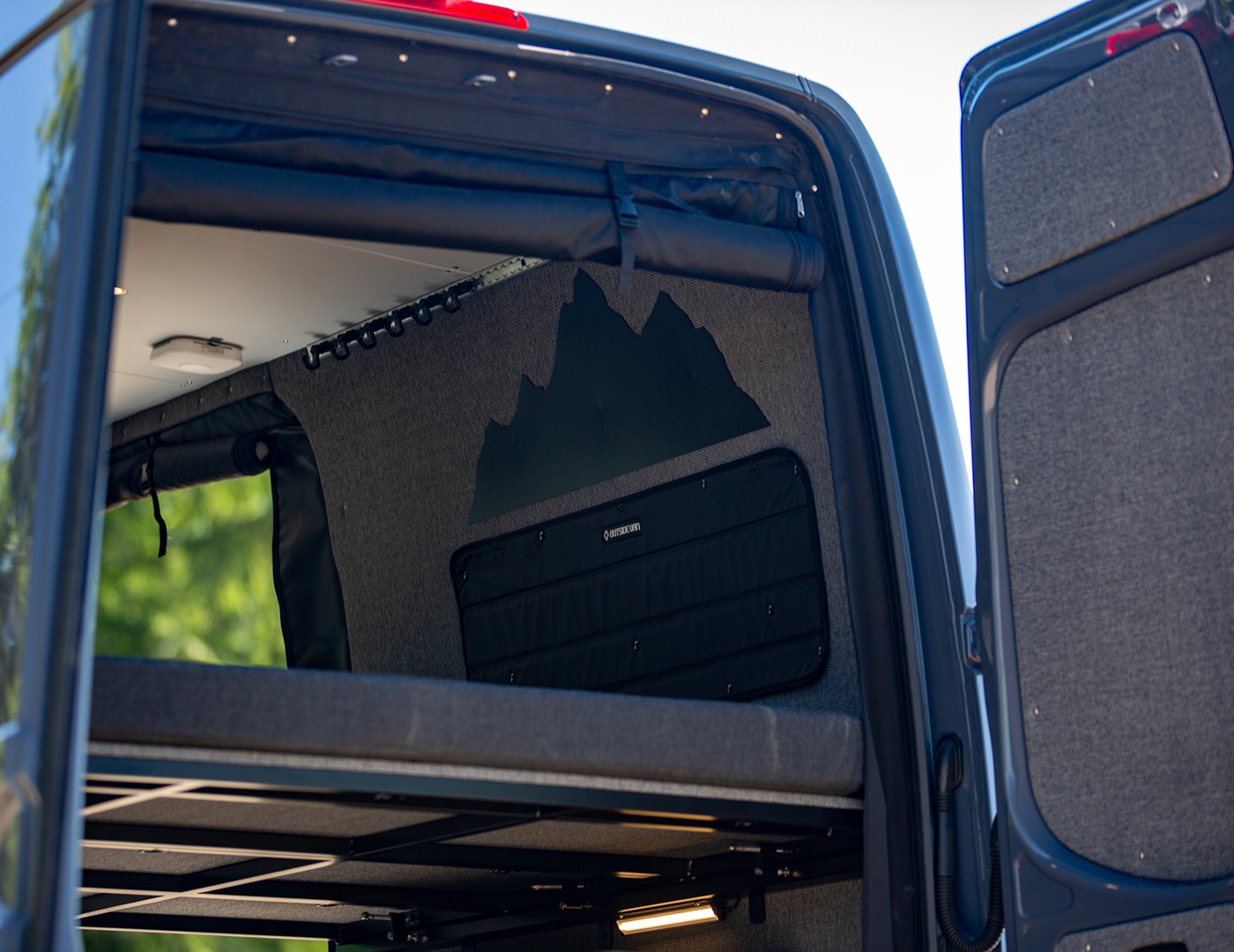 Detail image of converted 144 sprinter van with custom mountain range cut out above rear window