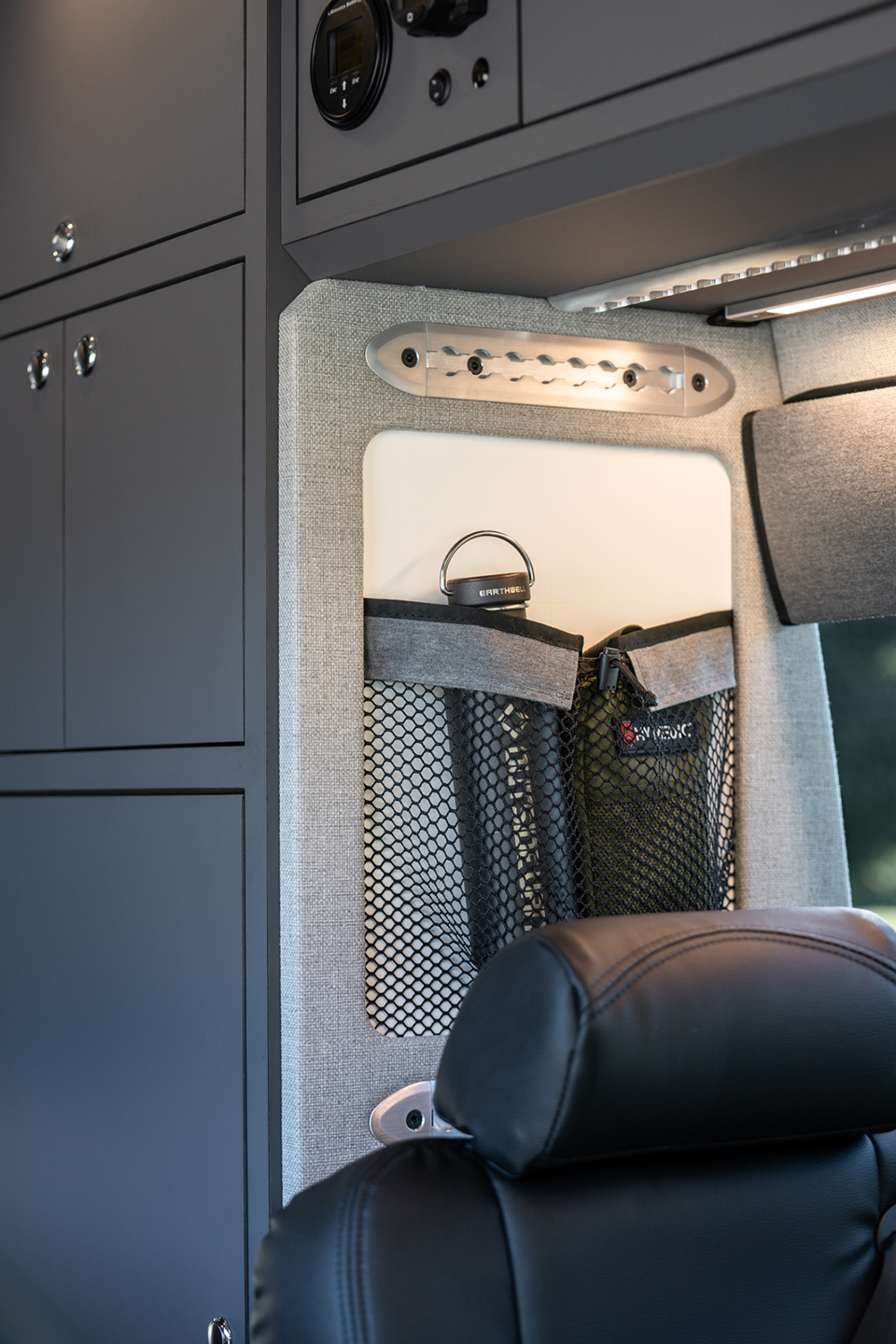 custom van conversion rucksack 2020 mercedes benz sprinter 170 4wd seat three sleep four interior storage cabinet overhead cabinetry