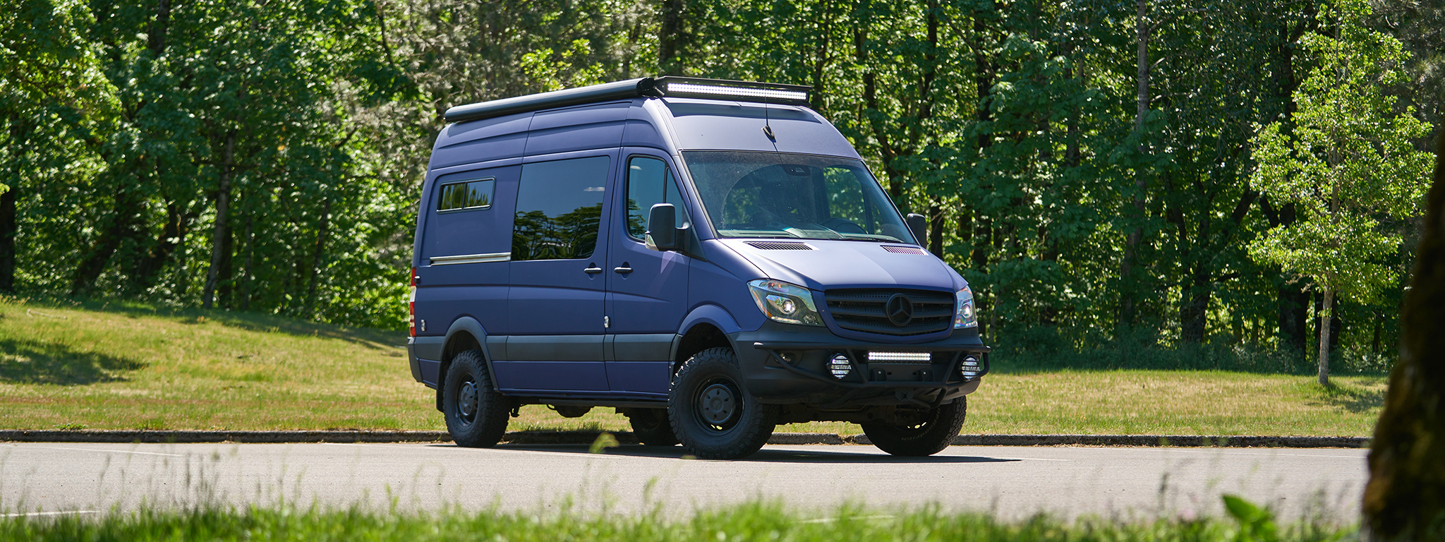 2018 Mercedes Sprinter with custom build and purple wrap by outside van for sale