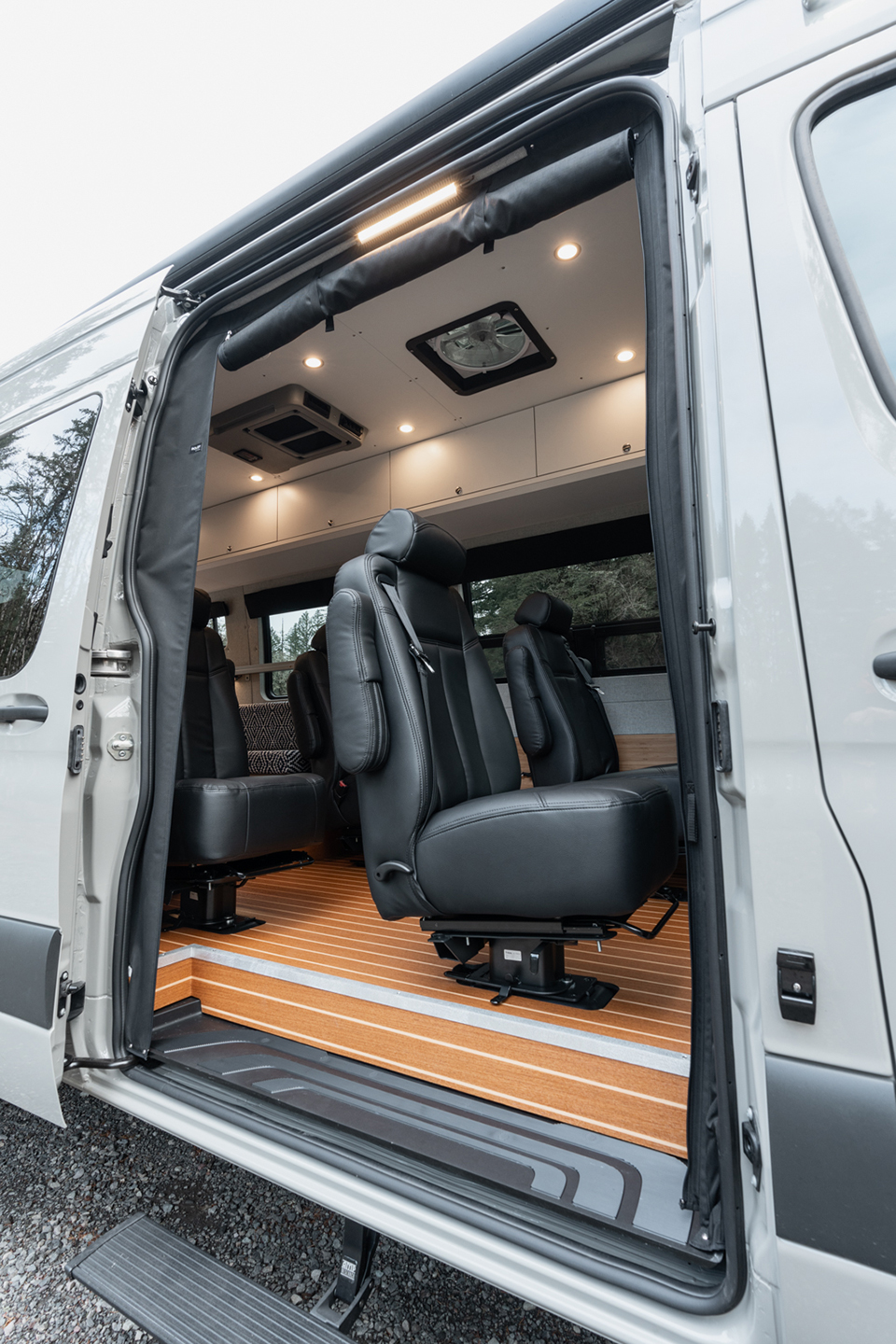 Passenger-side slider door open to four dot-approved captain's chairs