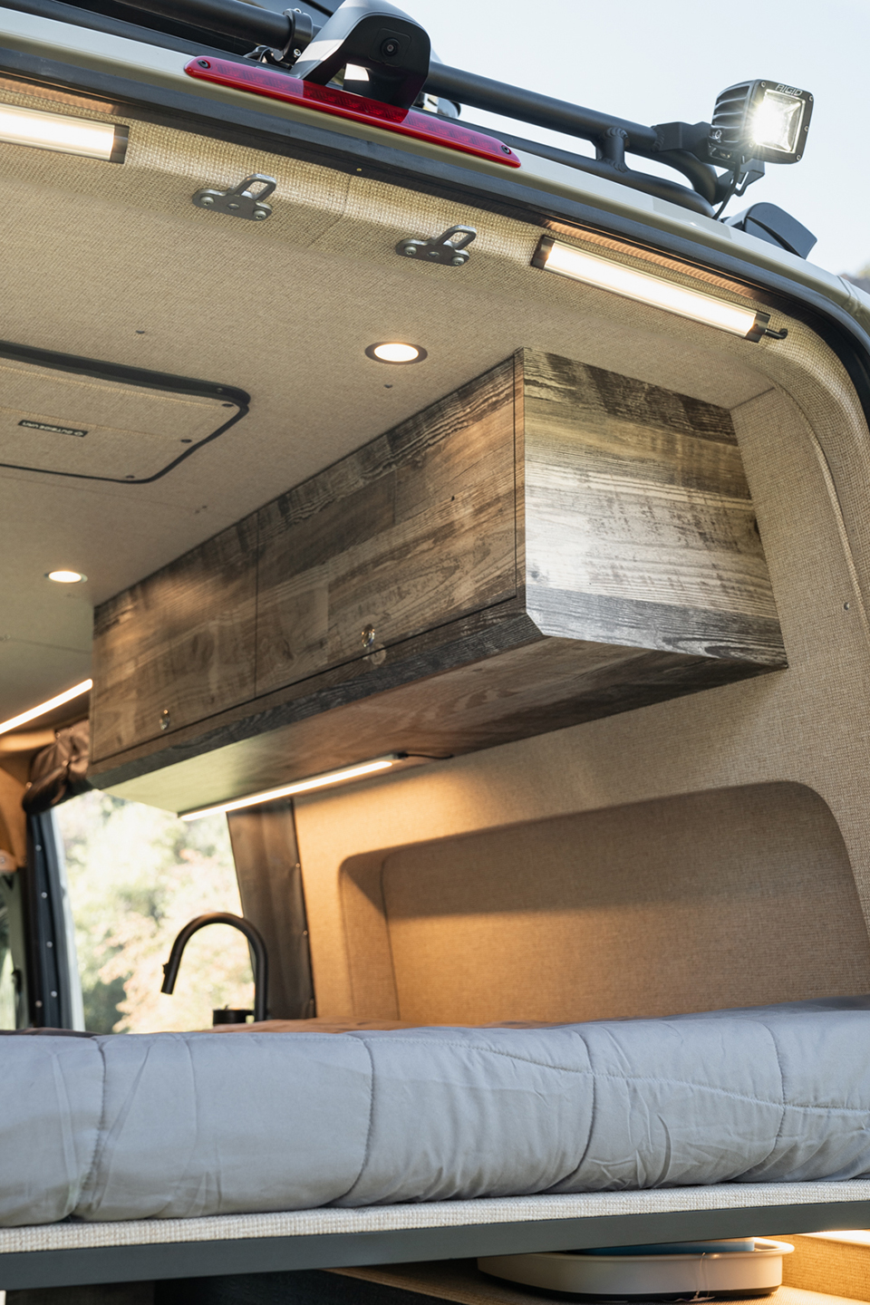 Interior sprinter van with enclosed overhead cabinetry