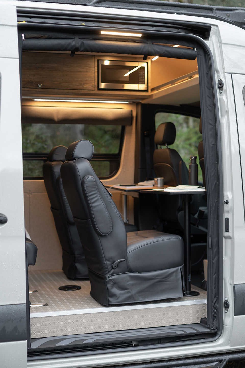 Passenger-side slider door open to two dot-approved captain's chairs