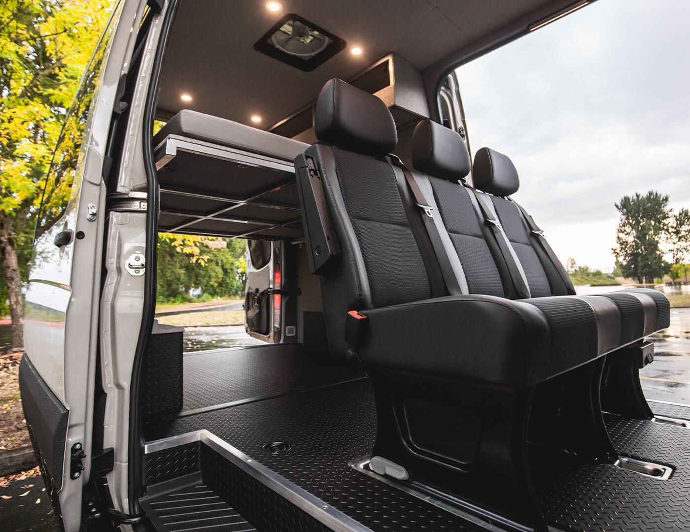 Aftresco is sleeping for two burt seating for 5 with duel slider doors custom conversion by Outside van