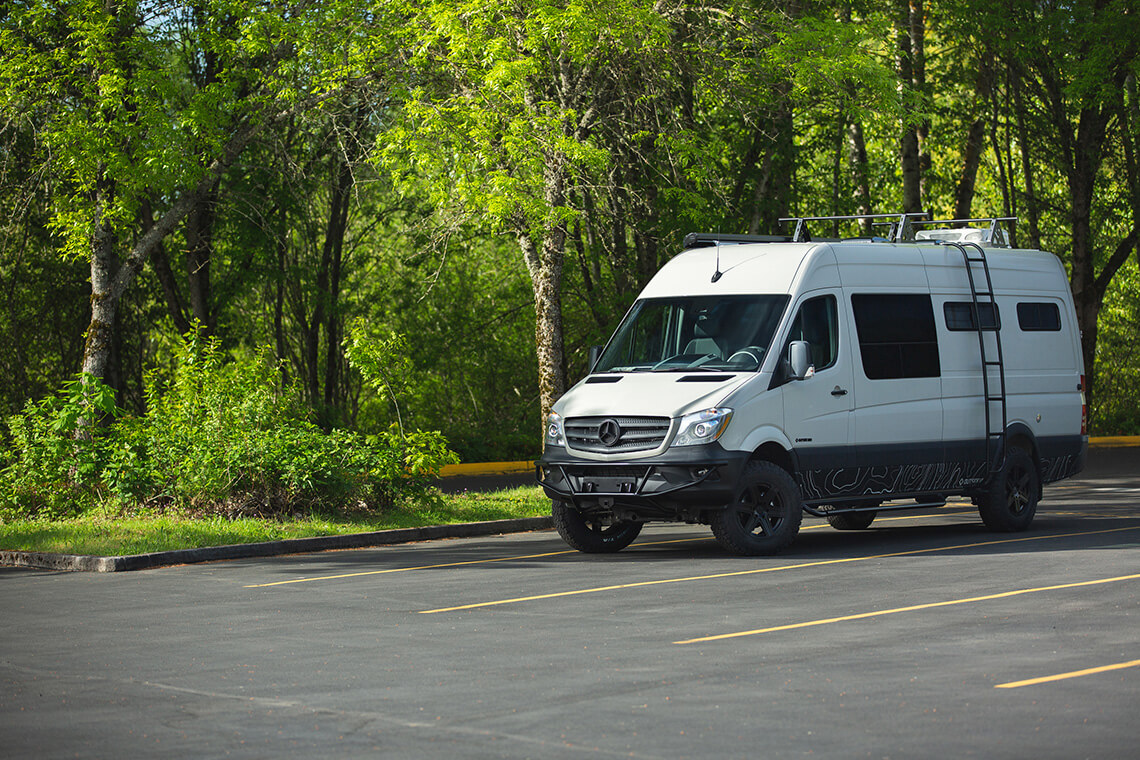 Bear's Den is an custom Outside VAn conversion for a family of 4 to camp in. exterior shower, galley, seating and sleeping for four